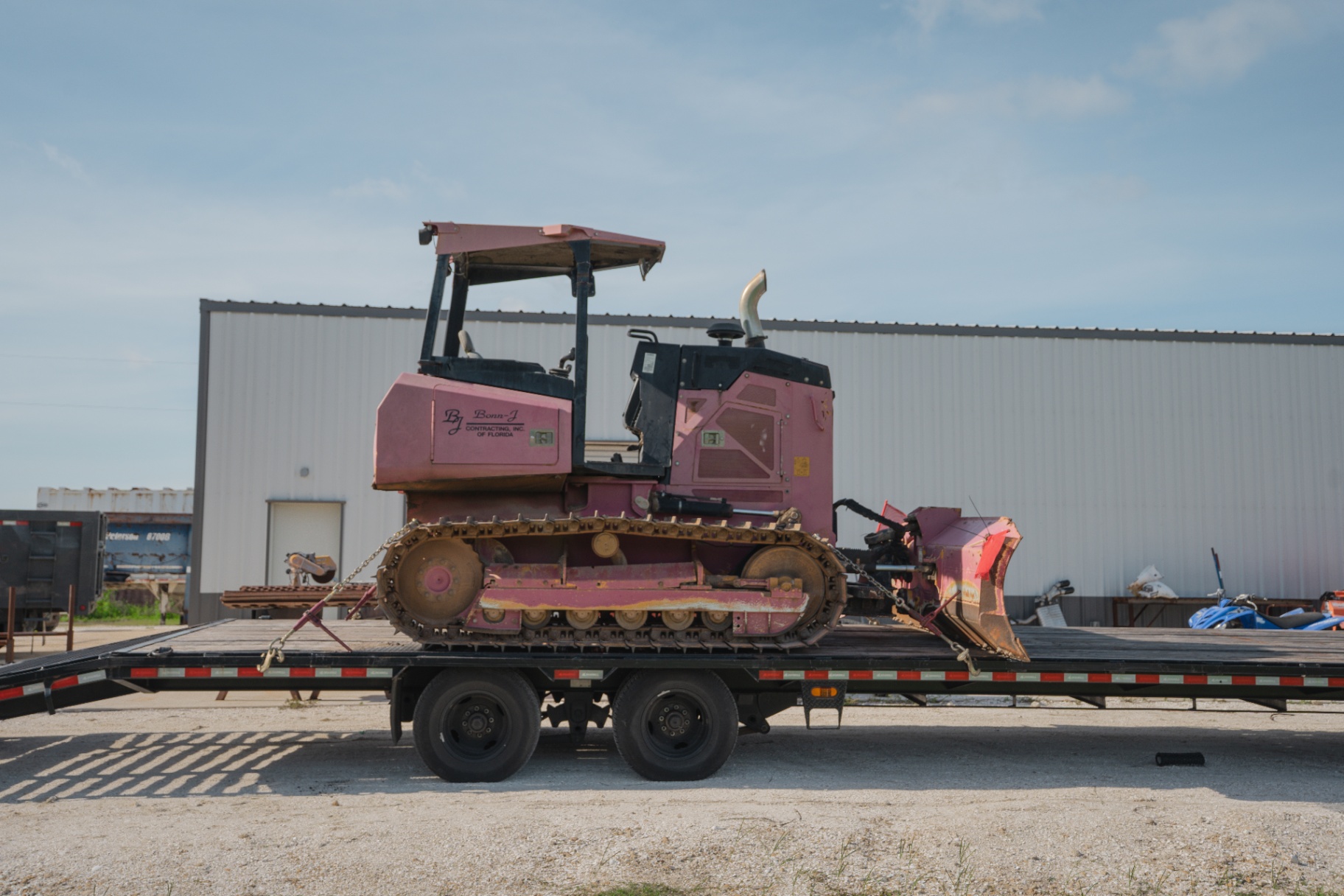 Tracked dozer loaded on trailer for transport