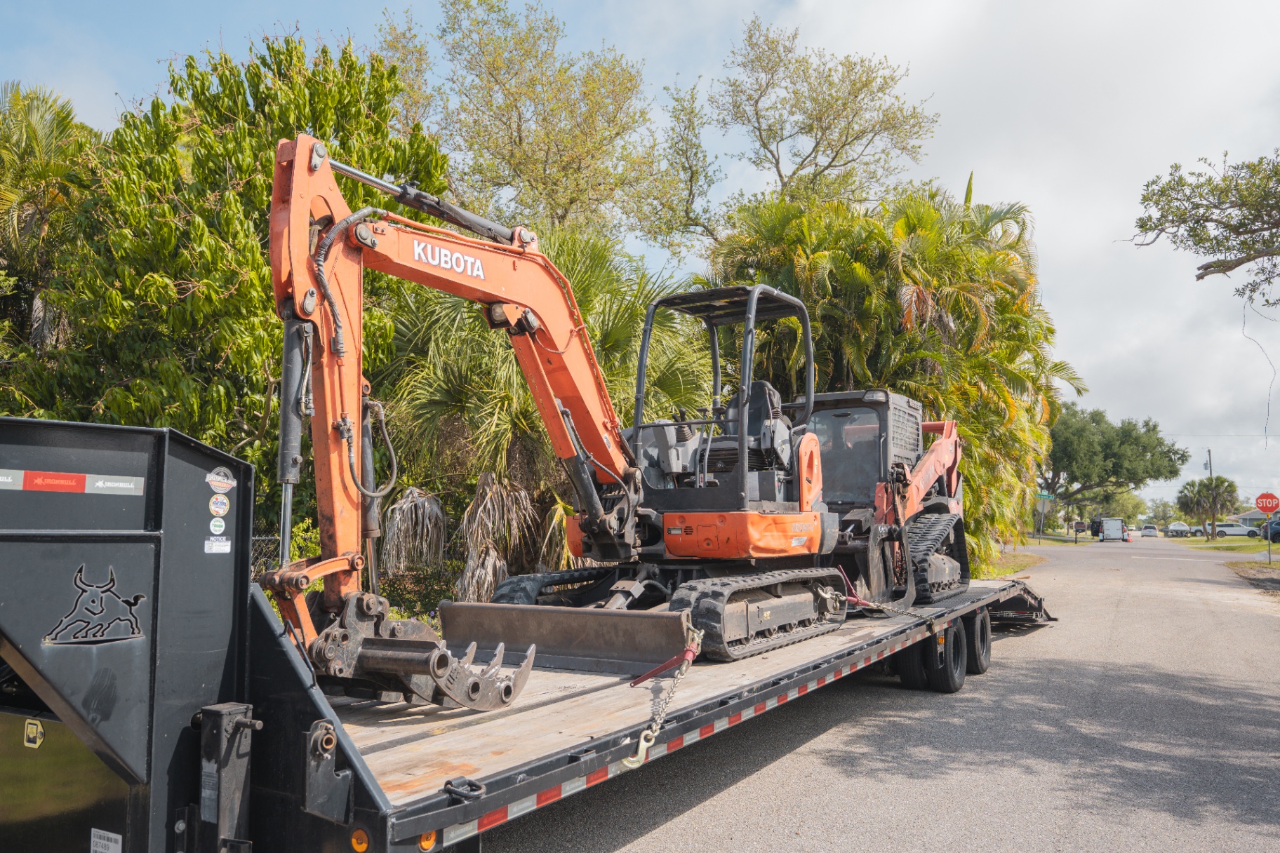 Kubota excavator and skid steer loaded on gooseneck trailer
