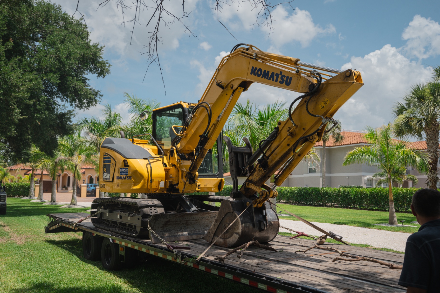 Komatsu PC88MR excavator on trailer at residential estate