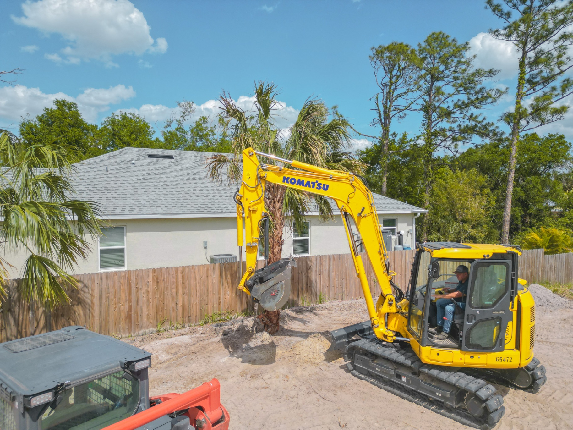Komatsu excavator digging on residential site